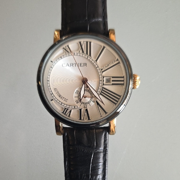HomageAutomatic Date Watch Goldtone and Black Band Watch with Roman Numerals.